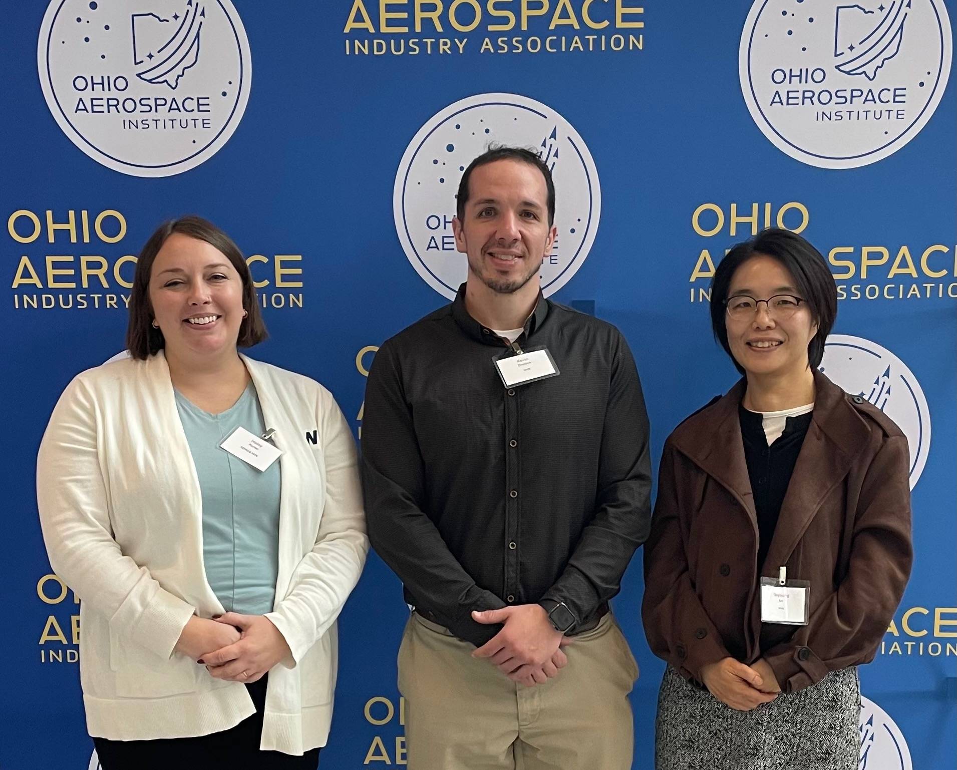 group in front of banner